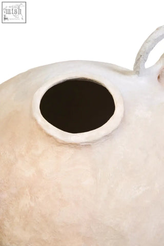Cream-colored sanai cotton mache large vase shaped like a cat with decorative handles and a circular opening