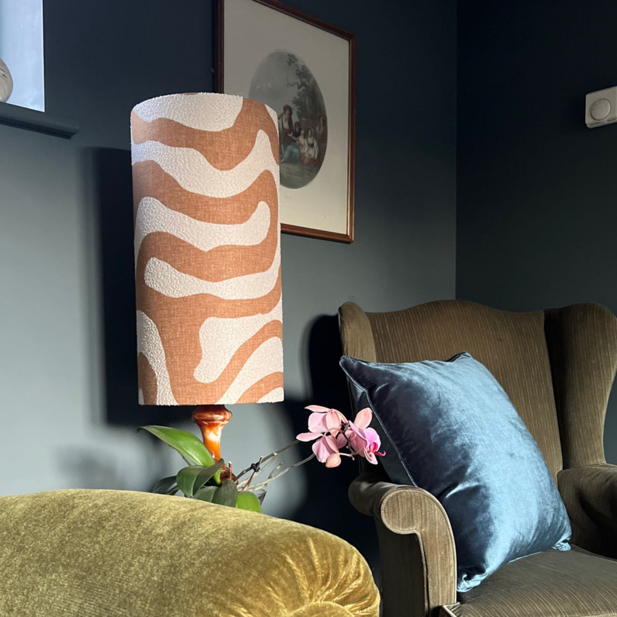 A bespoke handmade uk sandstone wiggle extra tall cylinder lampshade in earthy orange and cream with a fitting sits 3-4cm