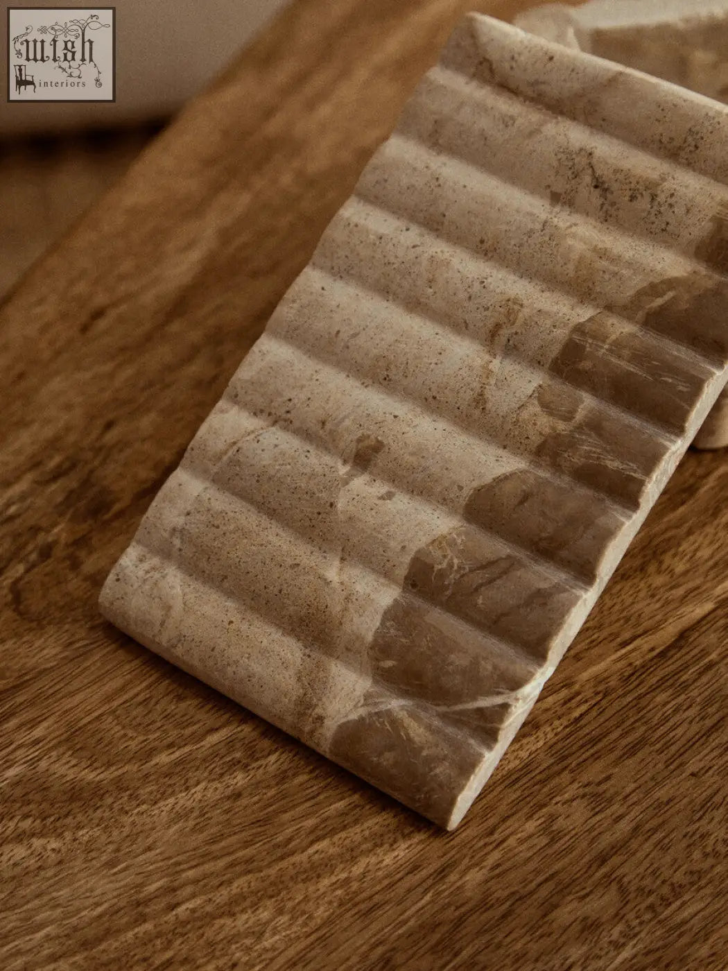 Beige stone soap dish with textured ribbed surface and natural veining in santino rectangular chocolate marble box