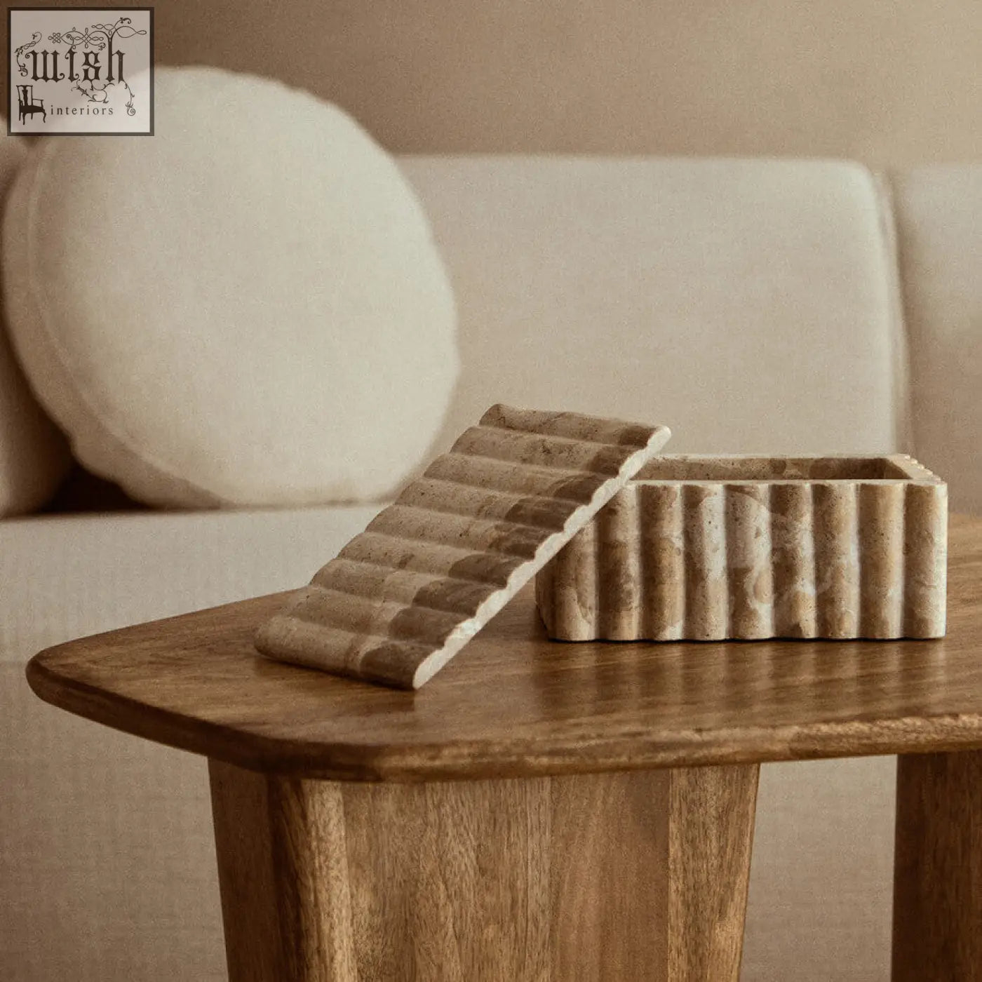 Beige stone santino rectangular chocolate marble box with ribbed texture and open matching lid on wooden table