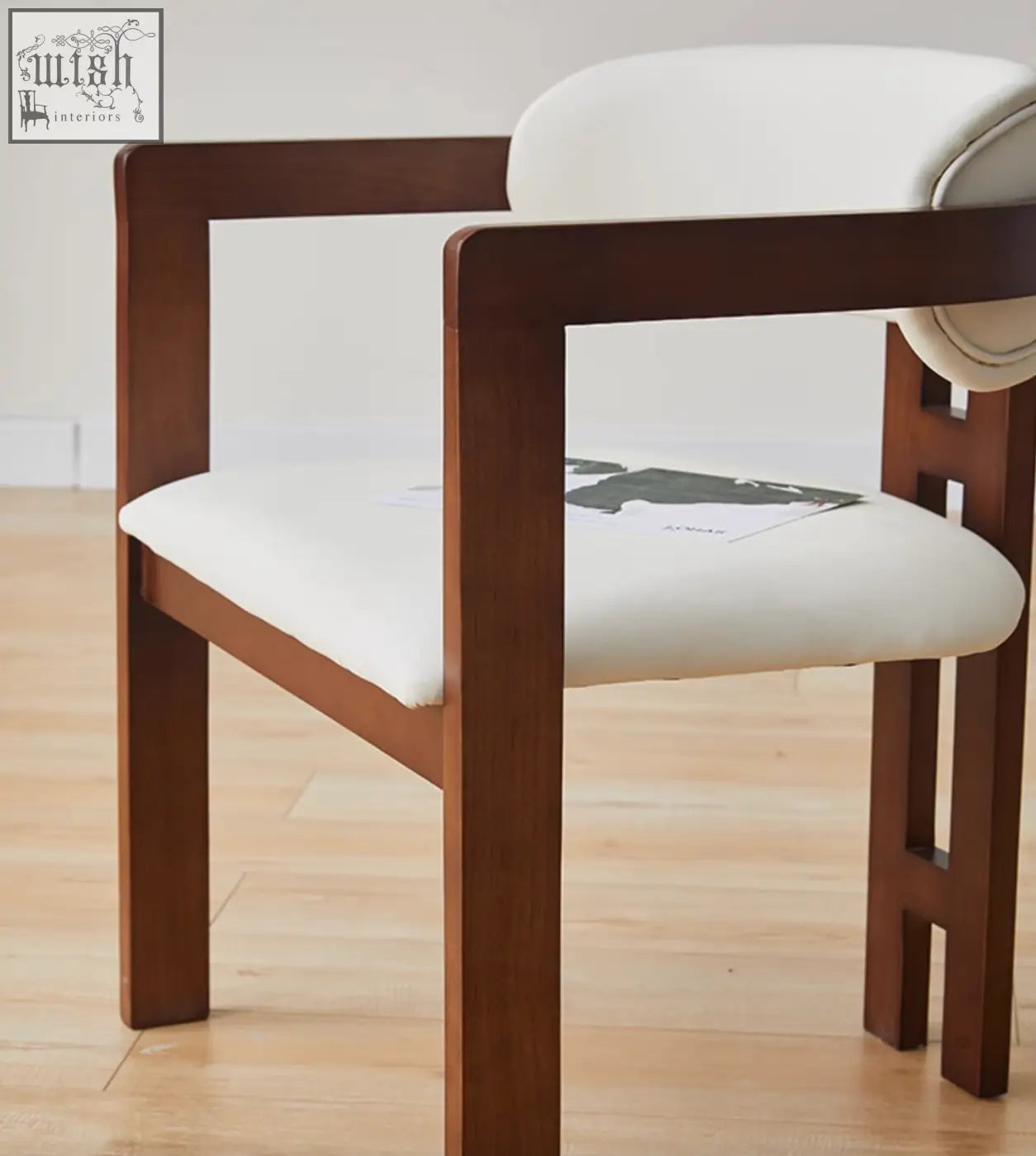 Sara dining chair wood with a minimalist brown wooden frame and plush white seat perfect for coffee table set areas