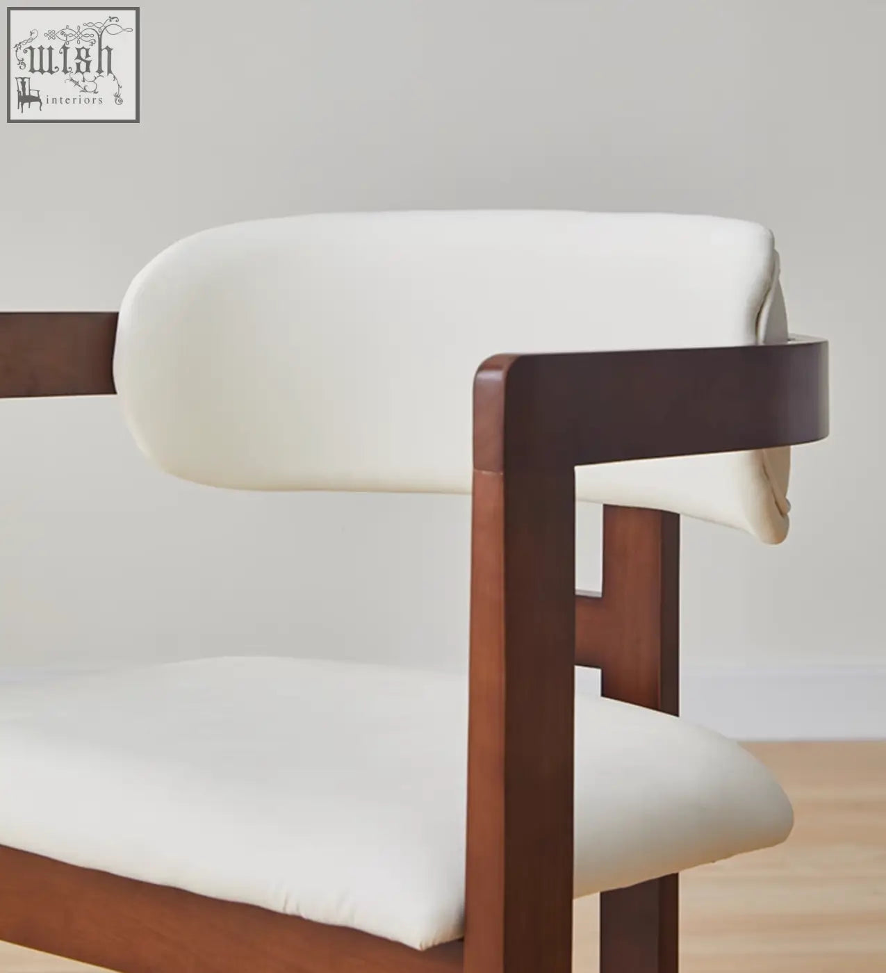 Sara dining chair with sleek dark wood frame and plush white upholstery complements any coffee table set