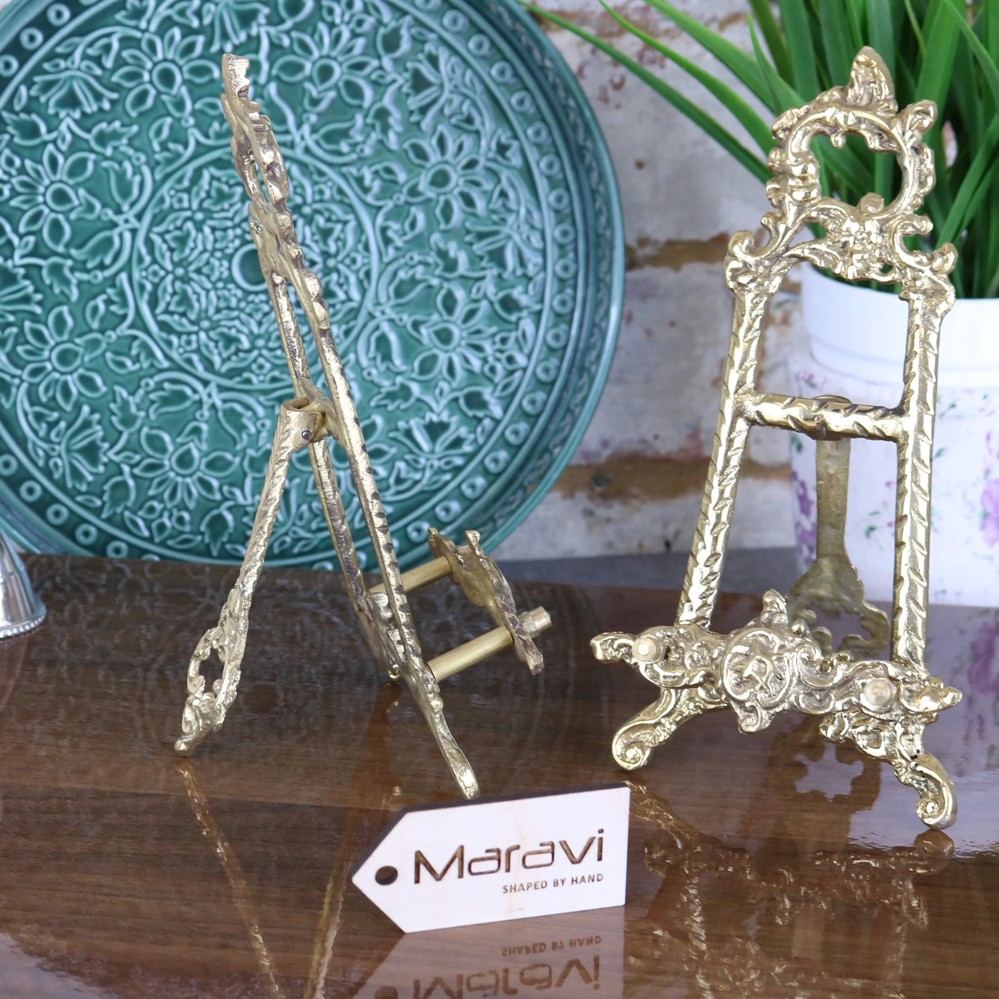 Two ornate hand-shaped brass easels with floral scrollwork from the saramati 20cm brass easel set of 2