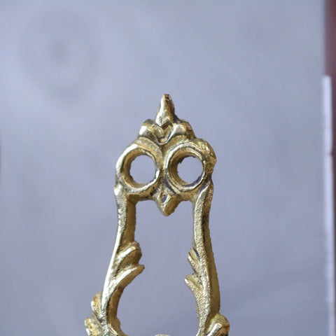 Golden owl-shaped brass door handle with ornate vintage design featured alongside saramati mini easel stands