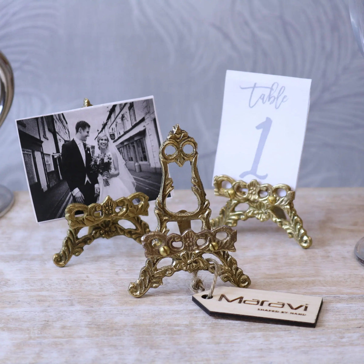 Ornate gold-colored brass mini easel stand with intricate scrollwork design from saramati set of 3 easel stands