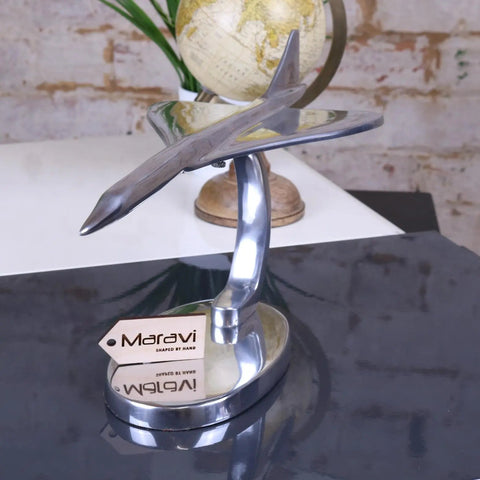 Shiny silver metallic saran concorde model airplane with sleek aerodynamic design and polished chrome finish 42cm