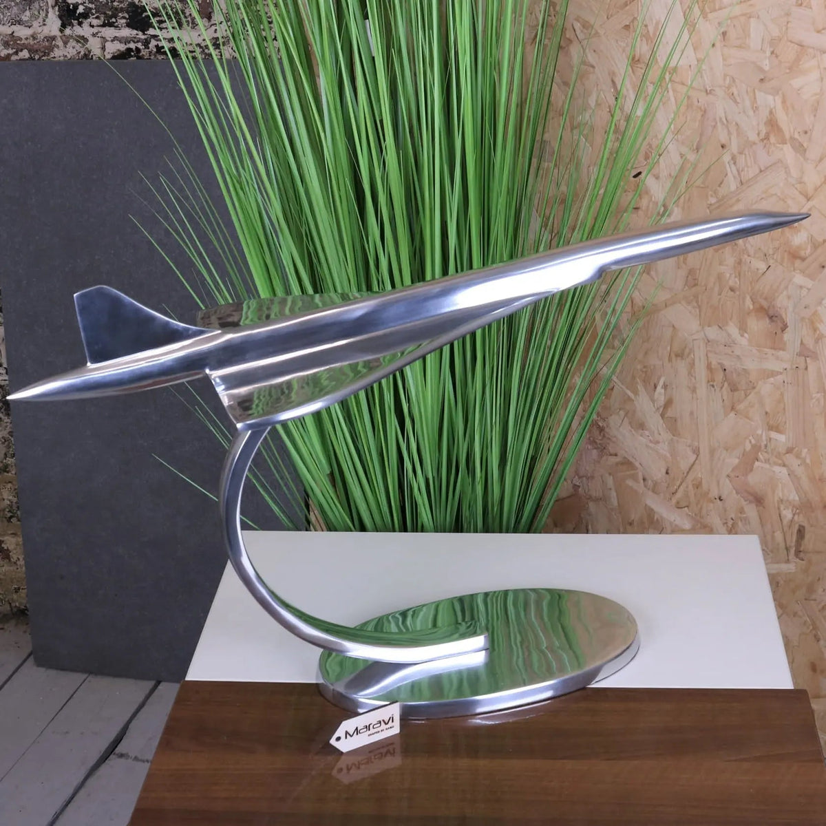 Shiny silver metallic saran concorde model 71cm airplane with sleek aerodynamic design on curved stand