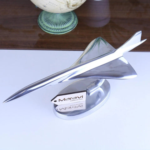 Shiny silver metallic concorde plane model on an oval base perfect for collectors or decor at 31cm long