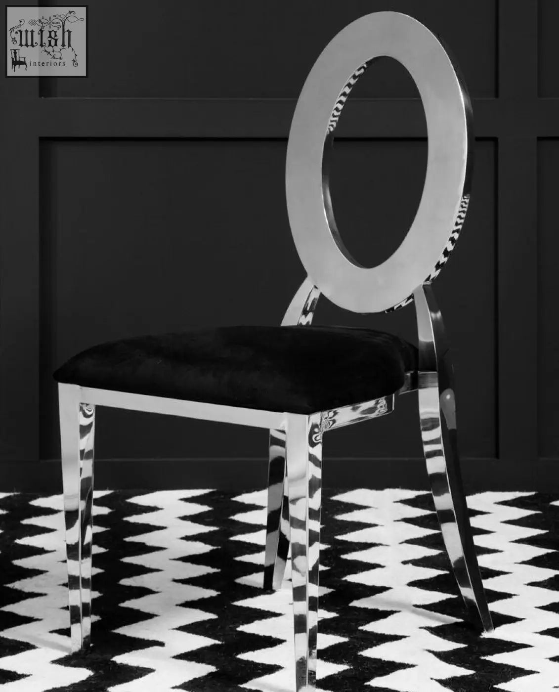 Sarita stackable silver frame dining chair with chrome finish, sleek oval back, and black velvet padded seat