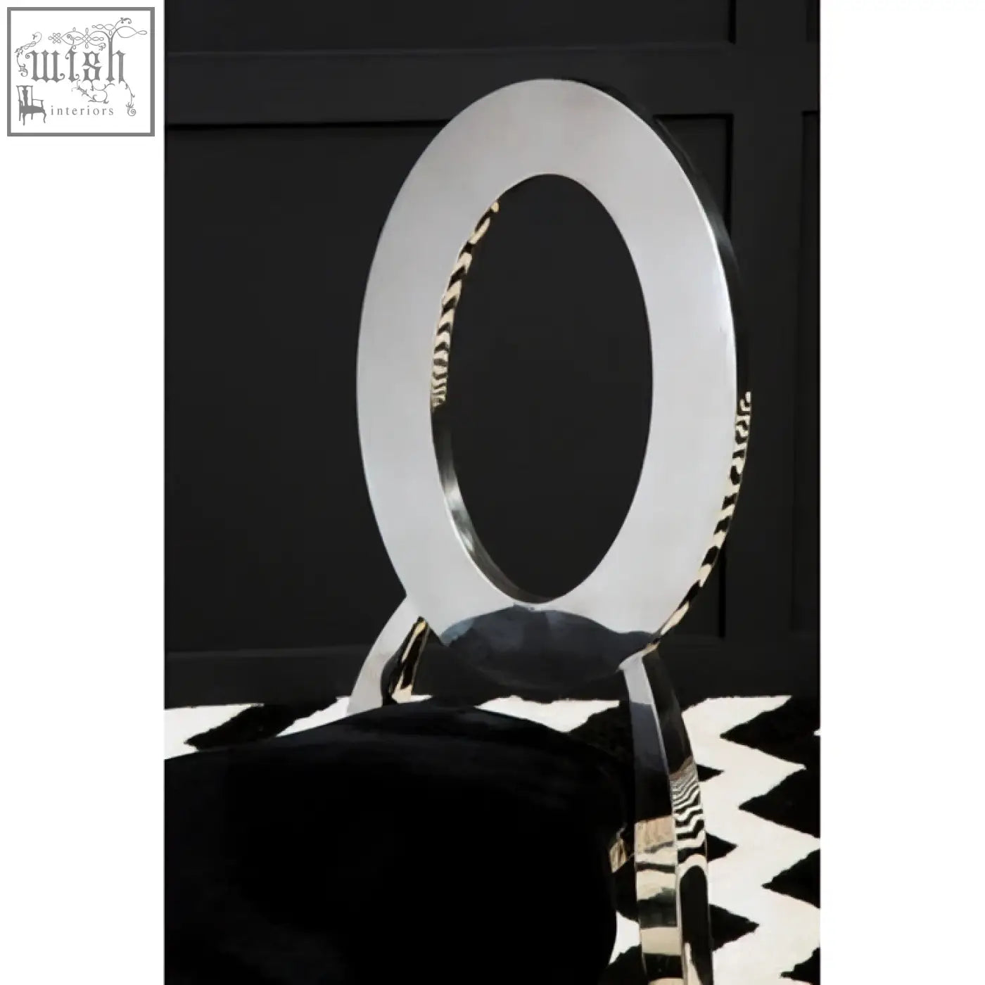 Sarita stackable silver dining chair with silver circular backrest and zebra-striped black velvet padded seat