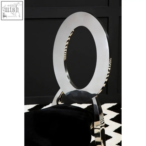 Sarita stackable silver dining chair with silver circular backrest and zebra-striped black velvet padded seat