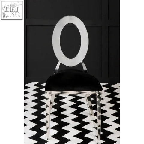 Sarita stackable silver frame dining chair with a sleek chrome frame and black velvet padded seat for dining comfort