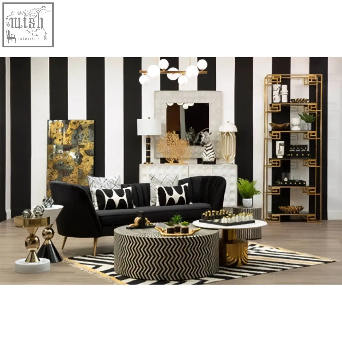 Black velvet sofa with gold-tone legs and geometric pillows shown next to the satara wall mirror
