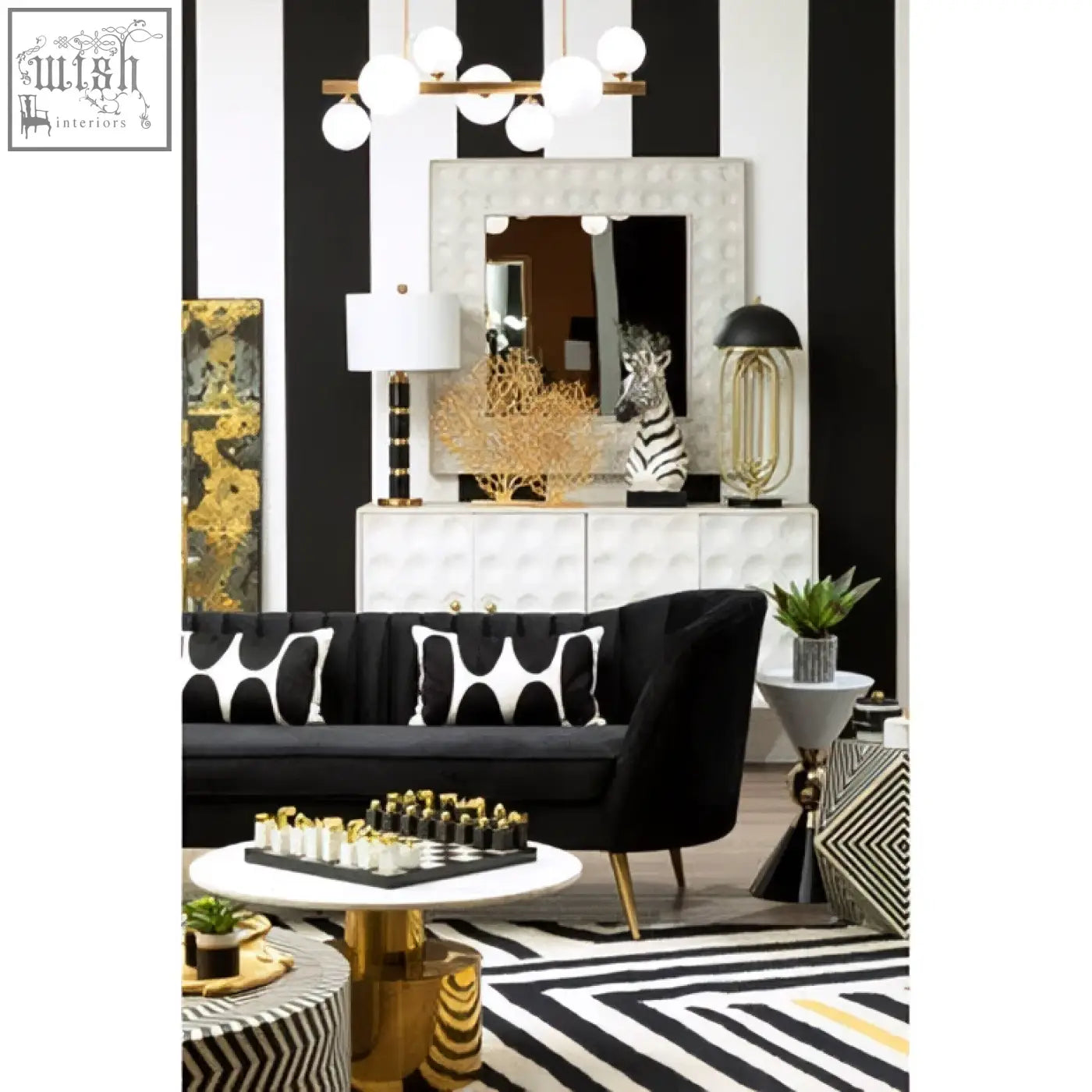 Black velvet sofa with white geometric cushions next to satara wall mirror in modern living room setting
