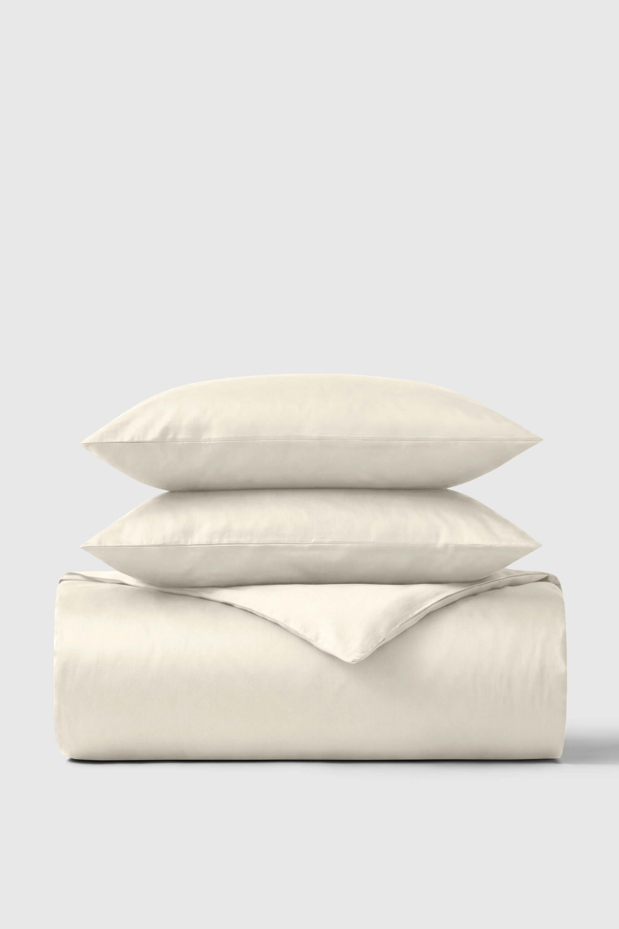 Cream-colored soft textured cotton sateen duvet cover set with matching pillows for cozy bedroom style