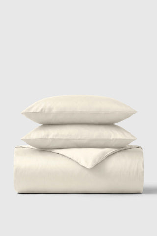 Cream-colored soft textured cotton sateen duvet cover set with matching pillows for cozy bedroom style