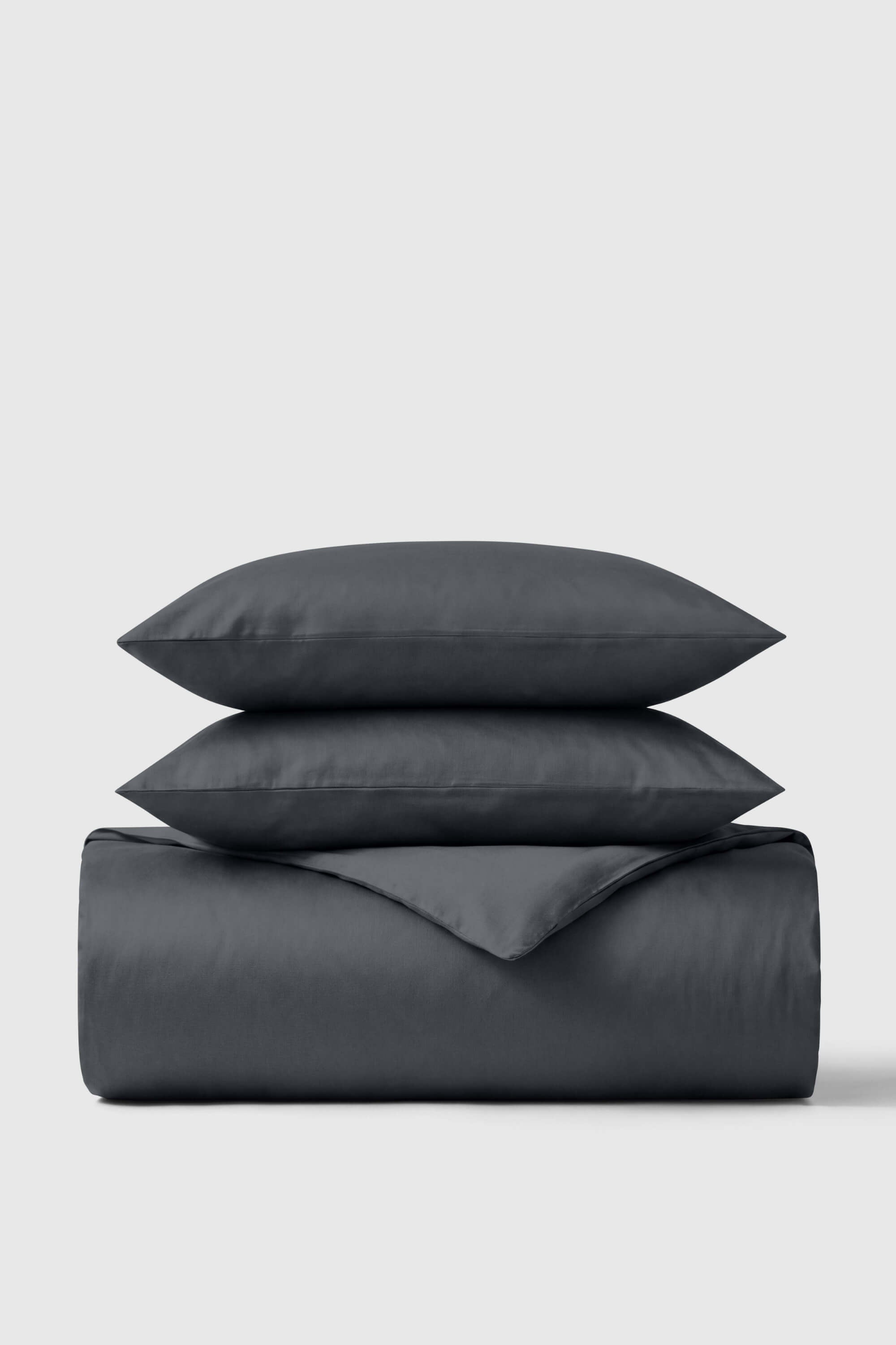 Dark gray smooth-textured cotton sateen duvet cover set with matching pillows perfect for a cozy bedroom look