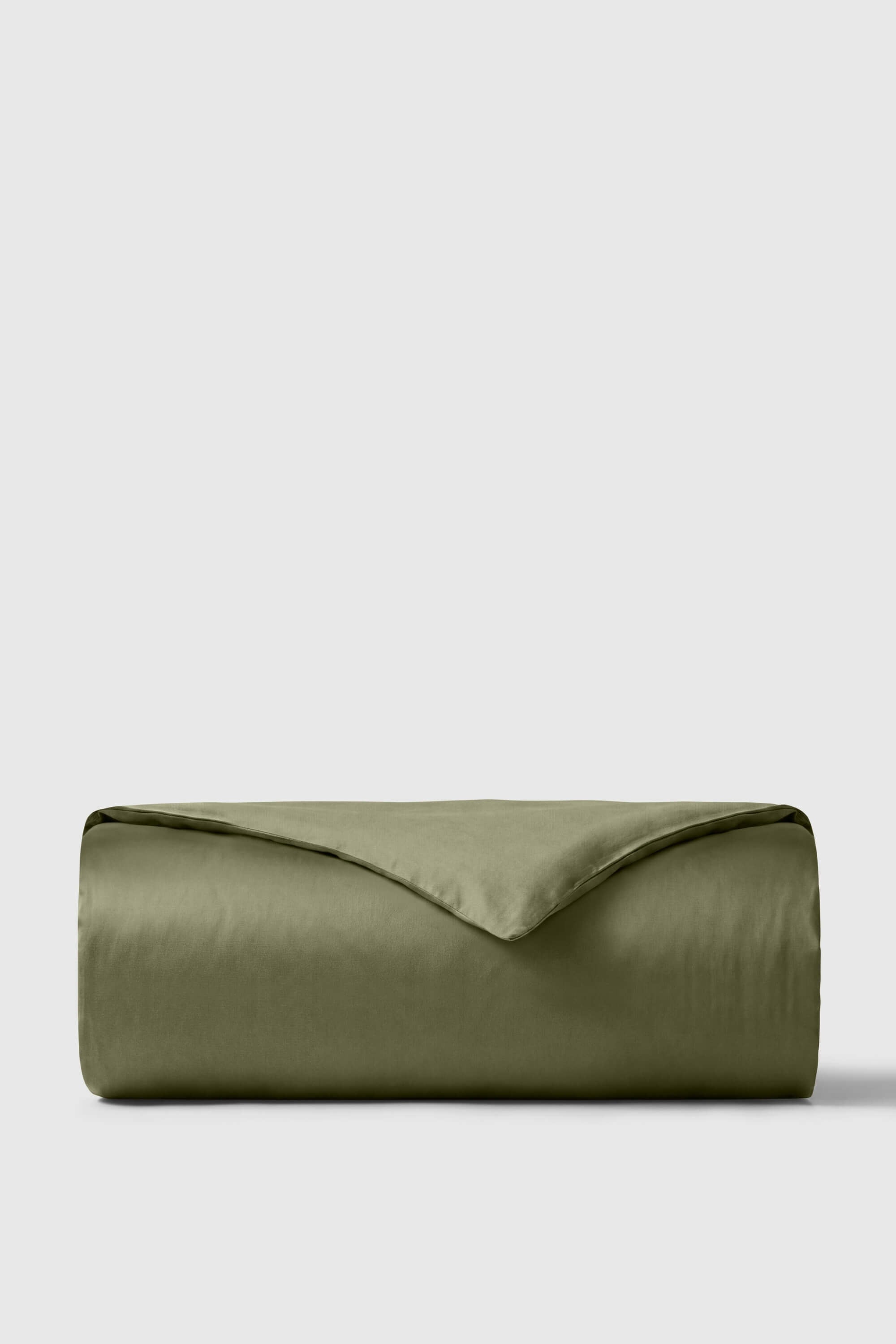Olive green sateen duvet cover neatly folded showing smooth satin texture perfect for cozy bedding setup