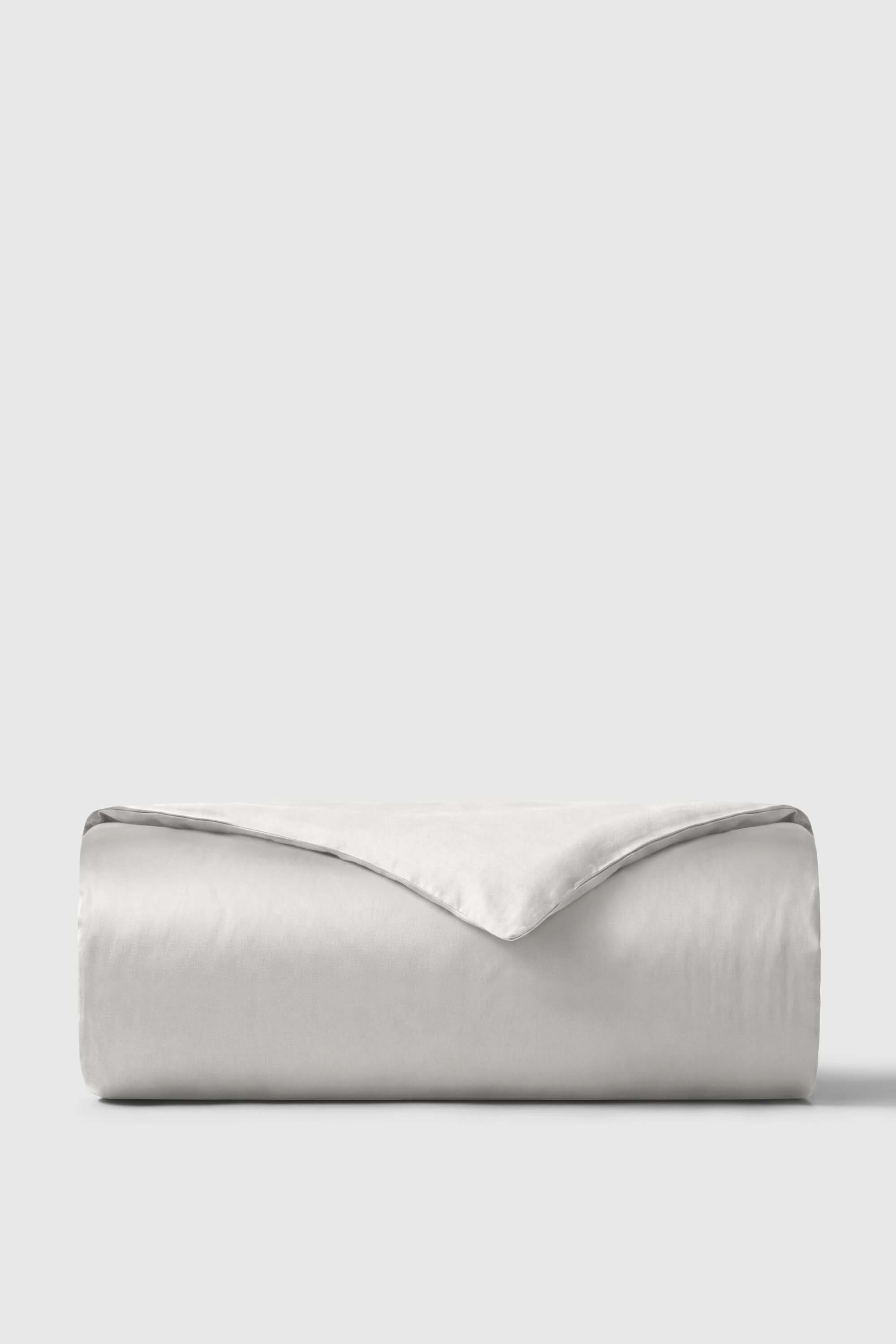 A soft light gray sateen duvet cover with a smooth satin finish and subtle sheen for cozy bedding