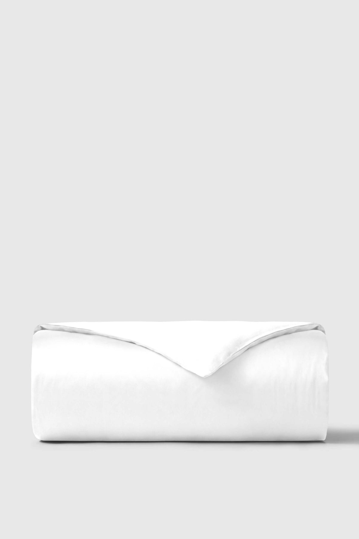 A crisp white sateen duvet cover with a smooth satin-like finish and neatly folded edges