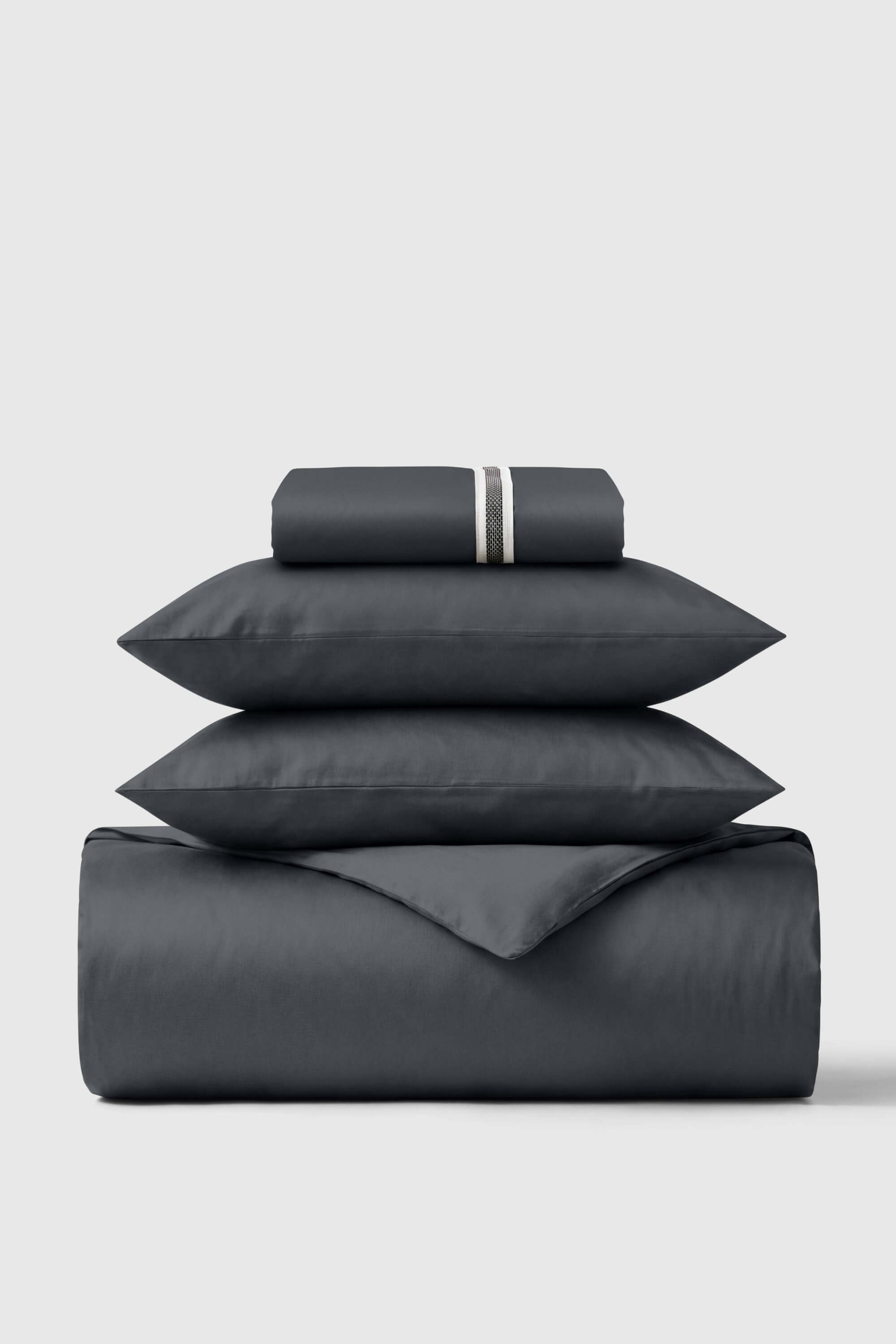 Dark gray satin sheet set with subtle textured stripe pillowcases in sateen essentials bedding set
