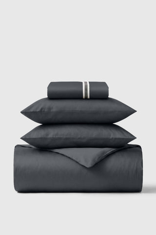 Dark gray satin sheet set with subtle textured stripe pillowcases in sateen essentials bedding set