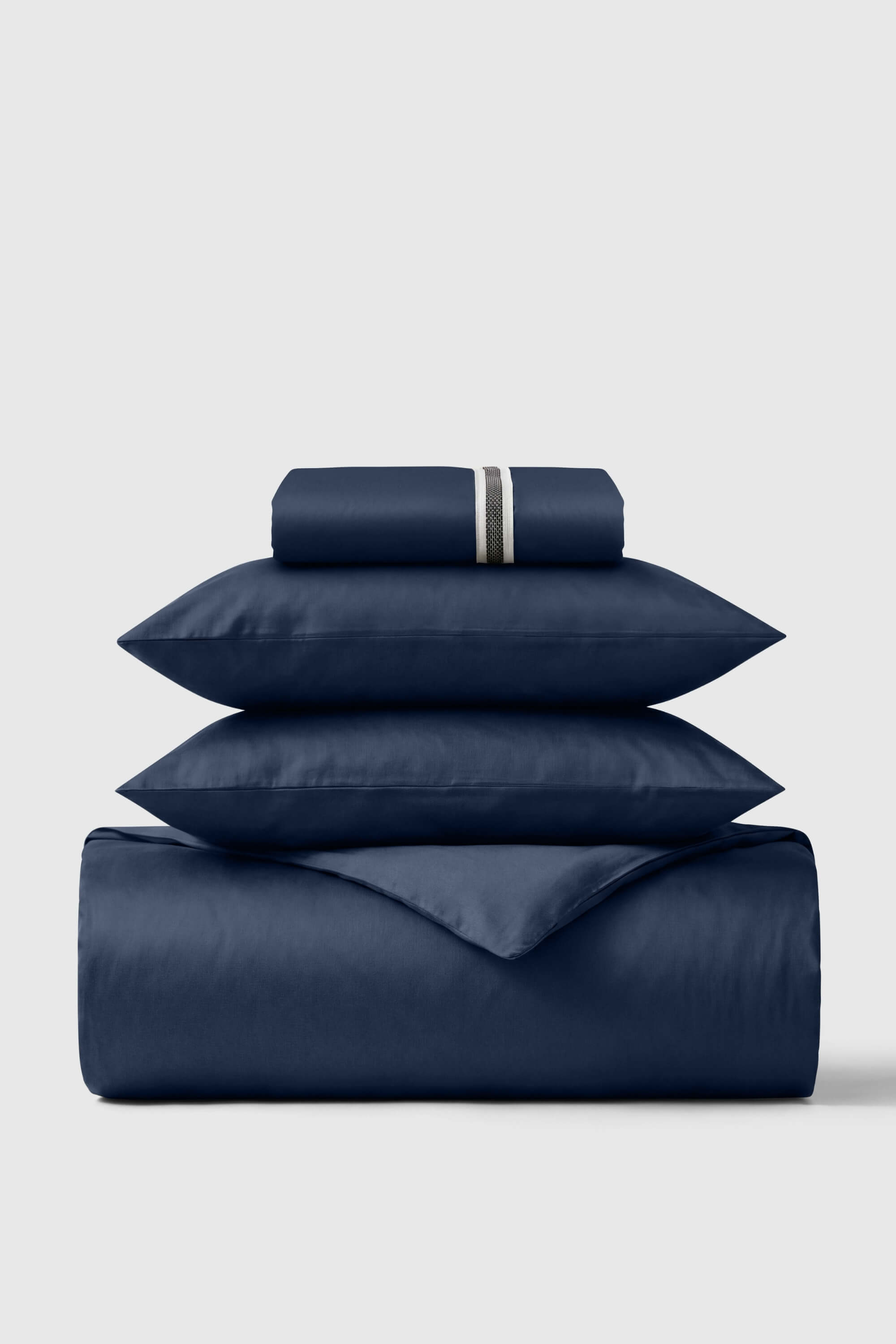 Navy blue satin sheet set with subtle metallic stripe on pillowcase from the sateen essentials bedding set