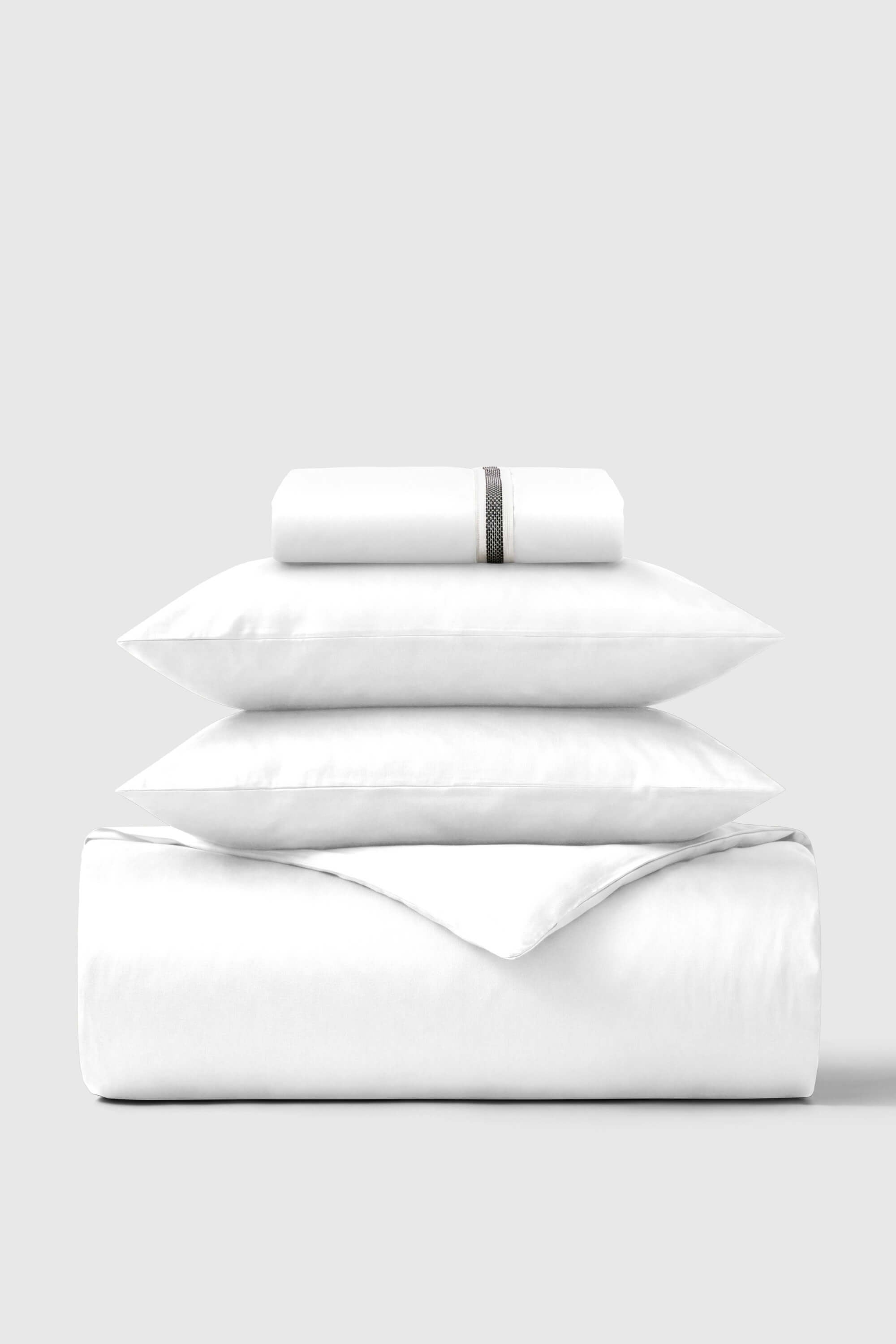 White cotton sateen essentials bedding set with subtle gray stripe detail on pillowcase for a cozy look