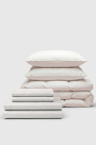 White cotton sateen move-in bedding set with quilted duvet and matching pillows for comfy bedroom style