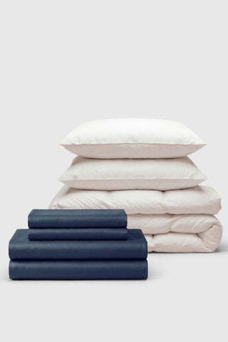 Navy blue satin sateen move-in bedding set with matching pillowcases and cream duvet cover for cozy bedrooms