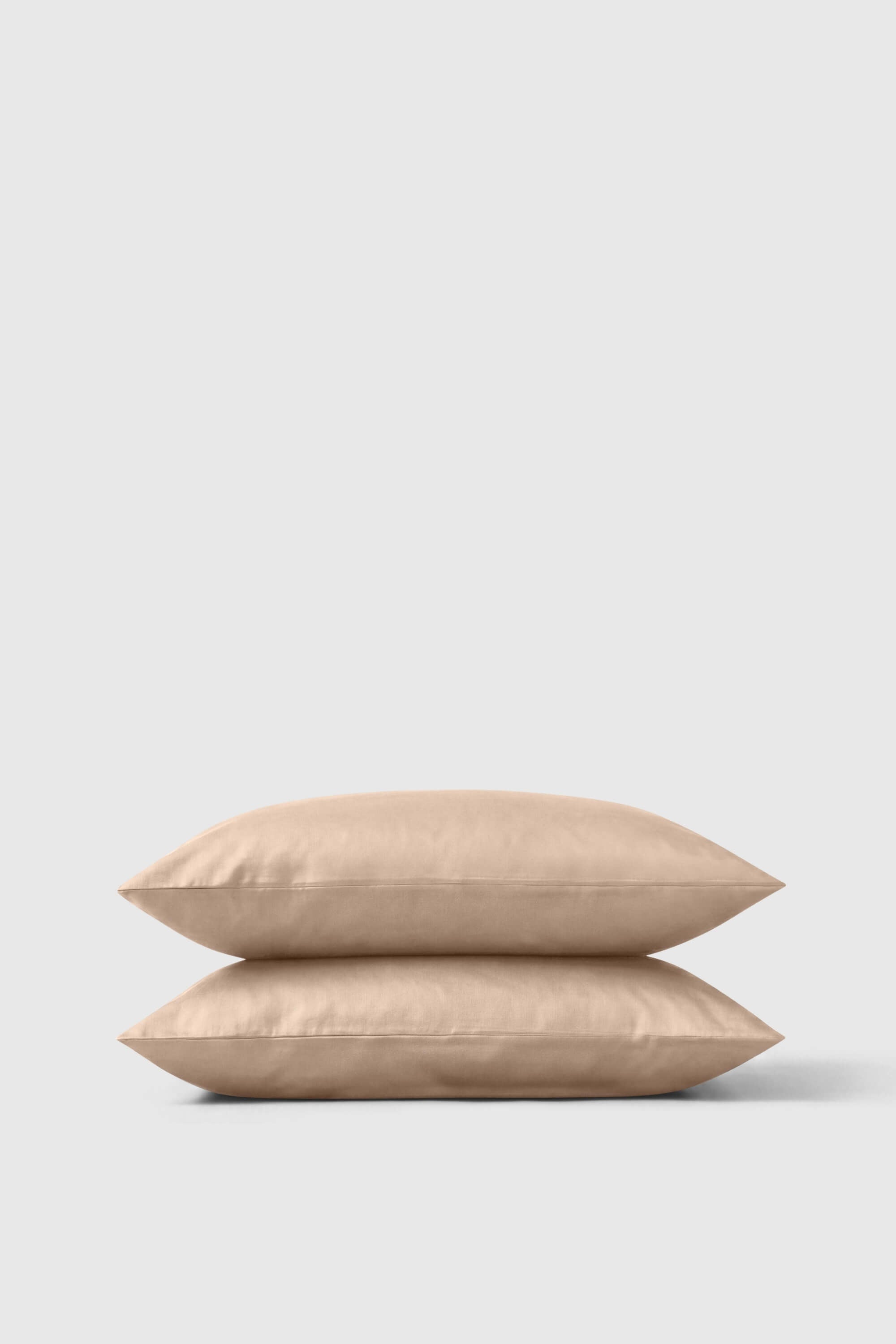 Beige sateen pillowcase pair neatly stacked for a soft and smooth bedding upgrade