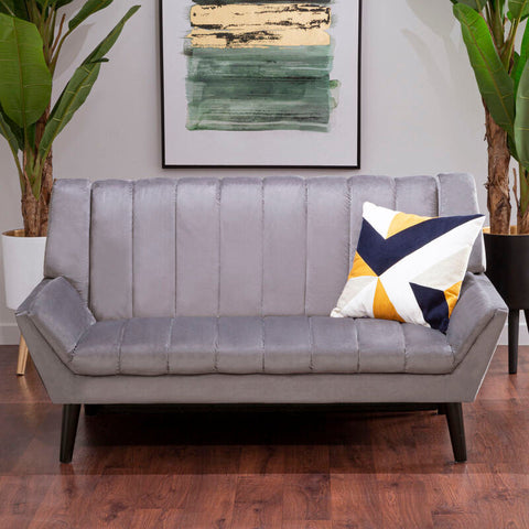 Gray velvet tufted savina 2-seat grey sofa with dark wood legs and a geometric accent pillow