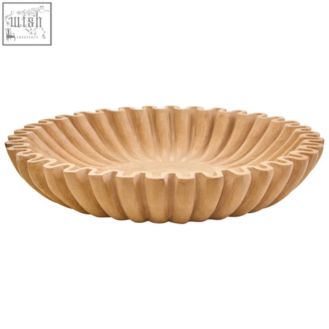 A light beige ochre marble bowl with fluted radial ridges and a scalloped rim perfect for serving or decor