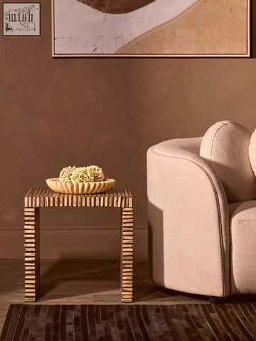 Rectangular side table with textured light brown wood and vertical slat legs holding a savio large ochre marble bowl