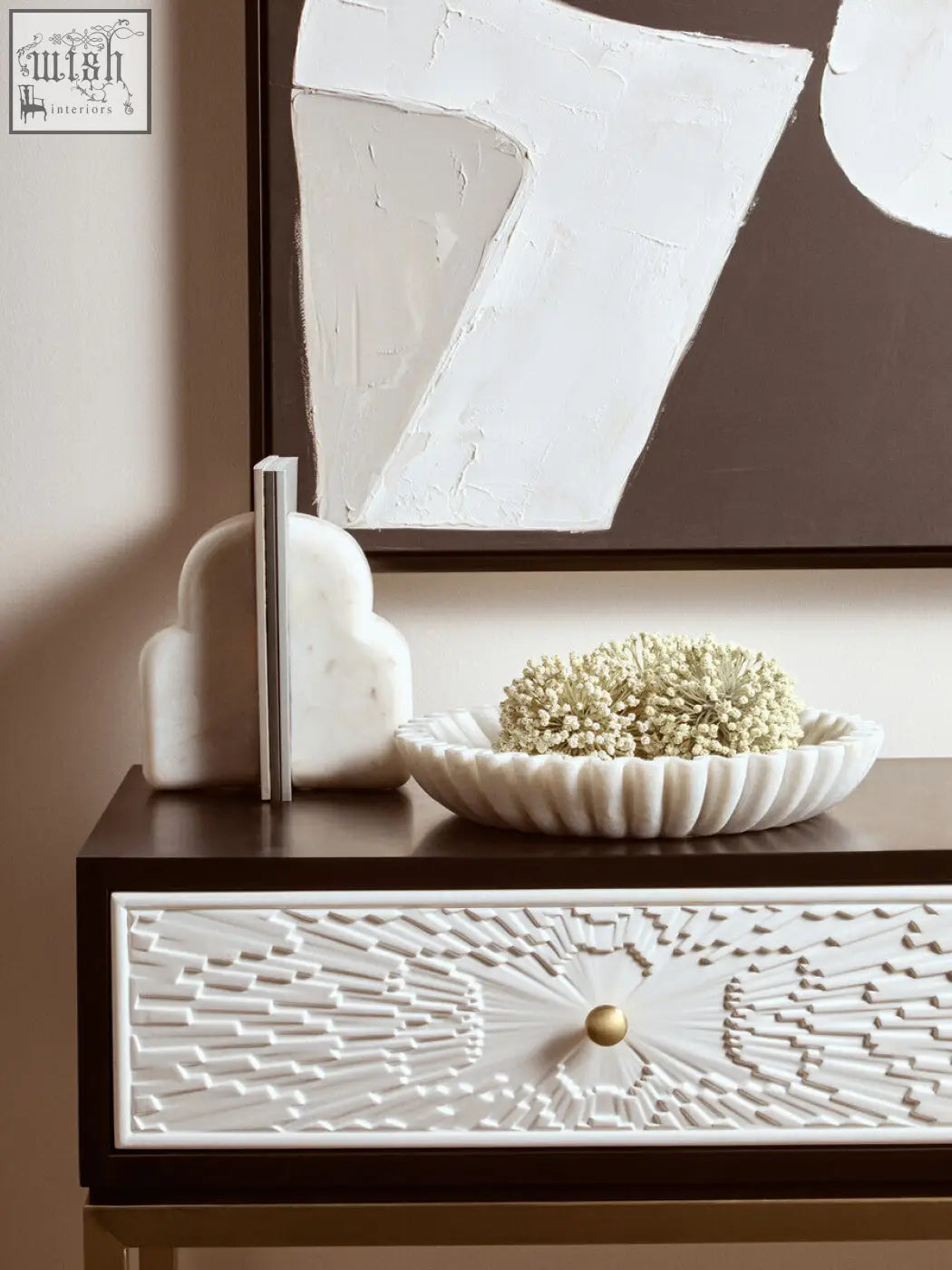 White marble bowl with fluted edges holding delicate white flowers in the savio large white fluted marble bowl