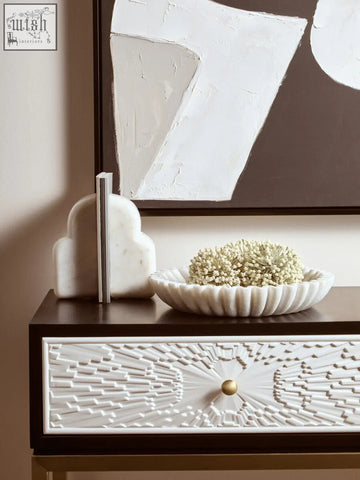 White marble bowl with fluted edges holding delicate white flowers in the savio large white fluted marble bowl