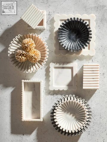 White marble bowl with scalloped edges and a fluted fan-like design perfect for serving or decor