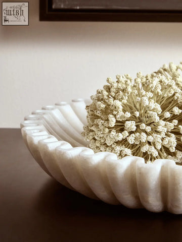 Creamy white marble bowl with fluted rim holding delicate dried flowers perfect for elegant decor display