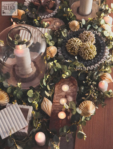 A rustic wooden candle holder with three circular spots paired with a savio rectangular white marble box with grey veining