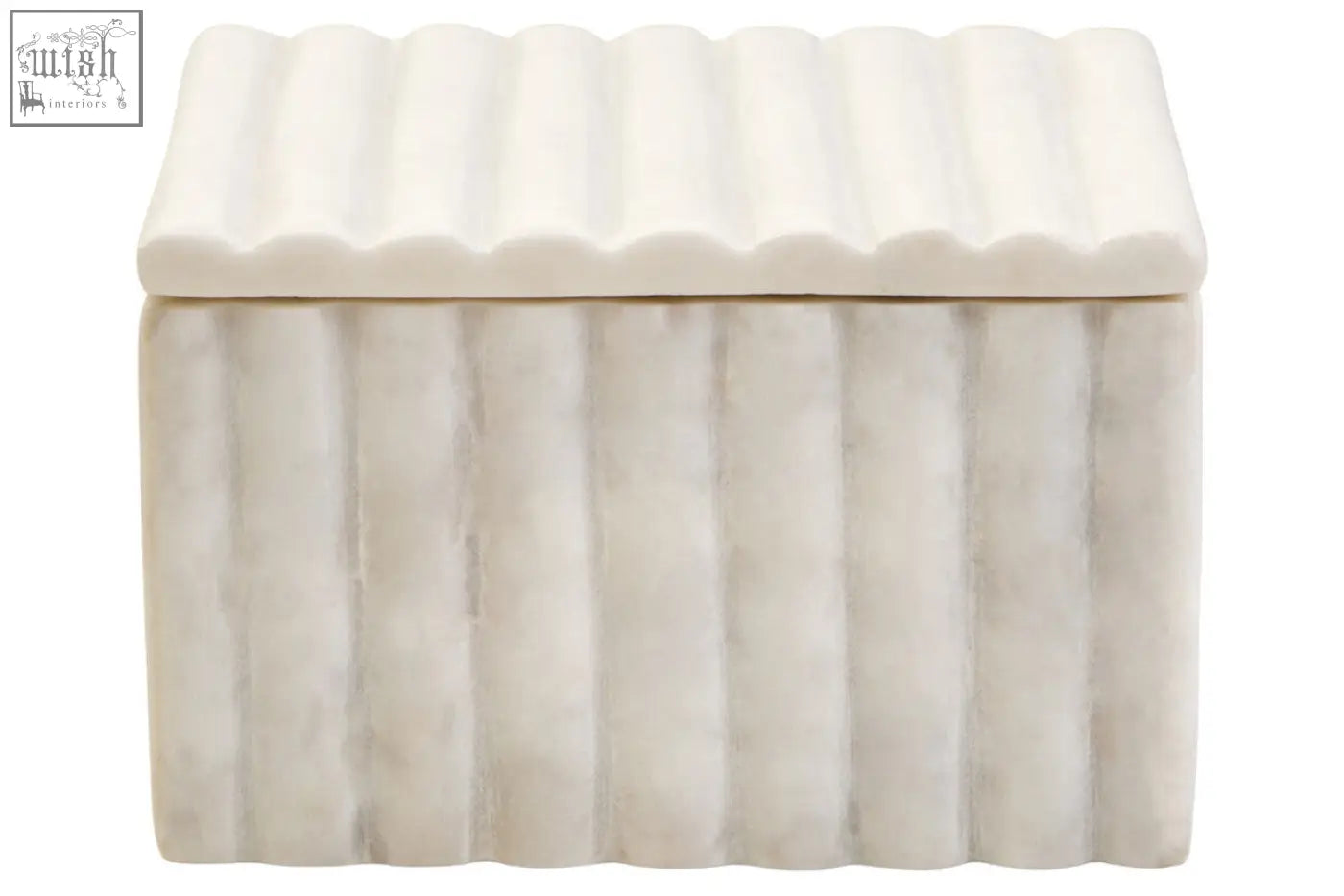 A white ribbed ceramic storage box with lid in the style of a fluted marble box for stylish storage
