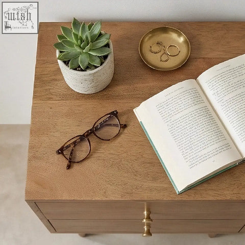 Brown tortoiseshell reading glasses rest on a wooden surface of a scandinavian light walnut oslo bedside table