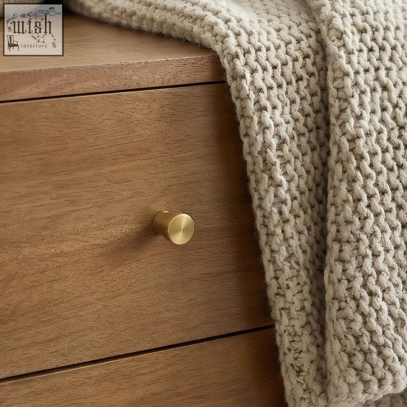 Gold-toned cylindrical drawer knob on a scandinavian light walnut oslo bedside table with light walnut finish