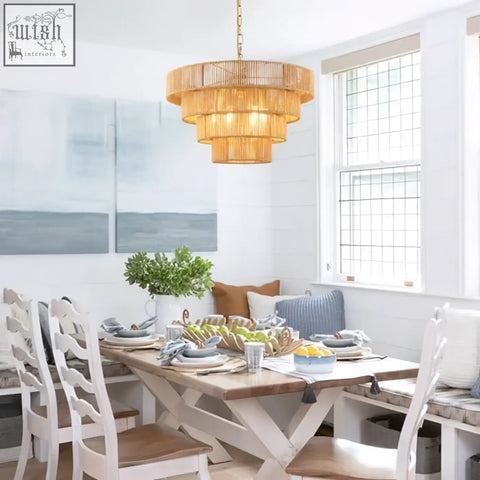 Golden tiered woven rattan pendant light with warm amber glow perfect for kitchen island or dining room lighting