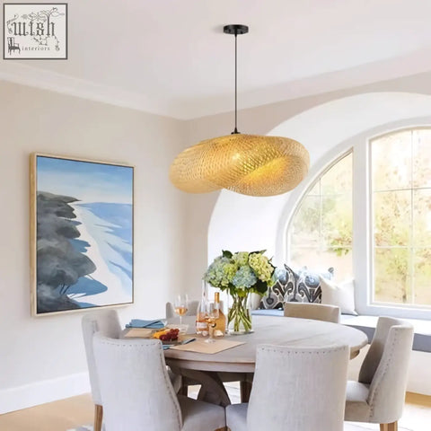 Golden woven pendant lighting with a textured straw hat design handwoven for boho dining and living room decor