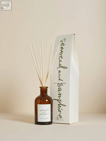 A sleek amber glass seaweed and samphire diffuser with white reeds and zesty citrus 100ml fragrance in vegetable oil base