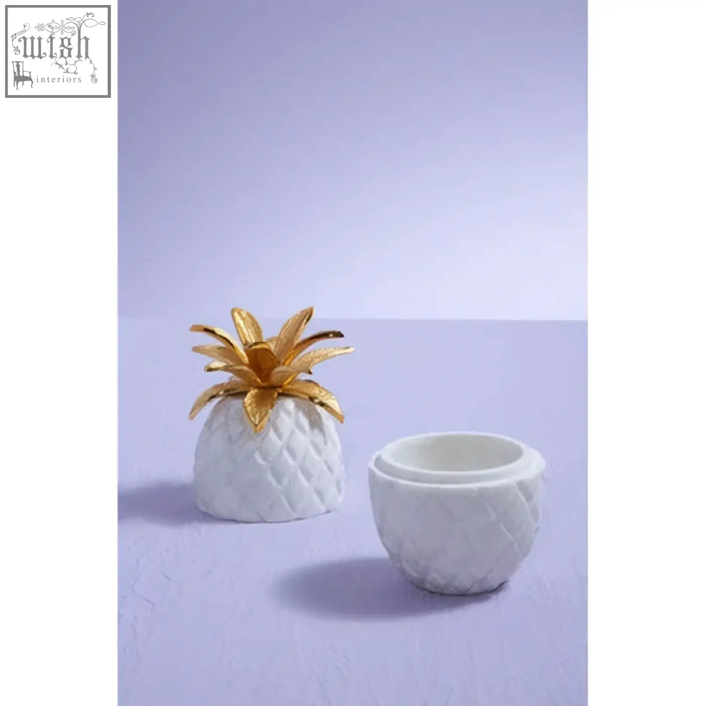 White ceramic sena pineapple jar with gold leaf crown resembling a white marble pineapple jar container