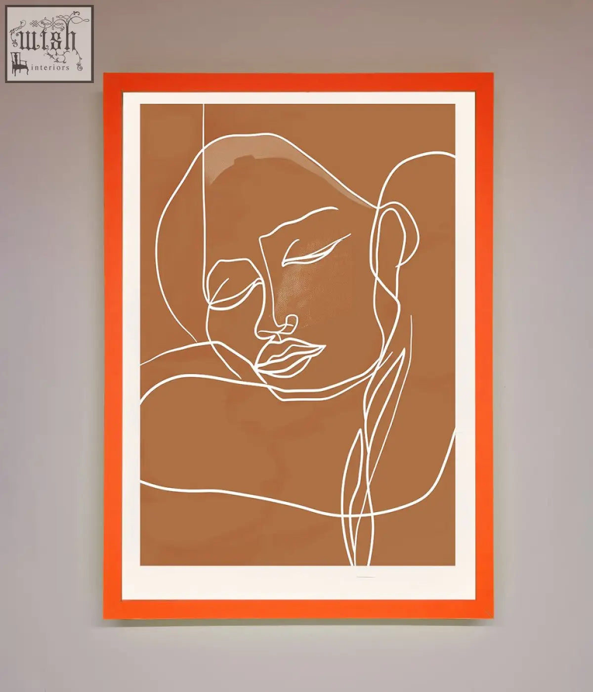 Sepia lines framed wall art featuring orange-framed minimalist line art portrait of a serene face on tan background