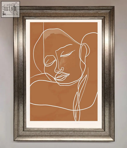 Minimalist sepia lines framed wall art with a serene white line-art face on terracotta background in silver frame