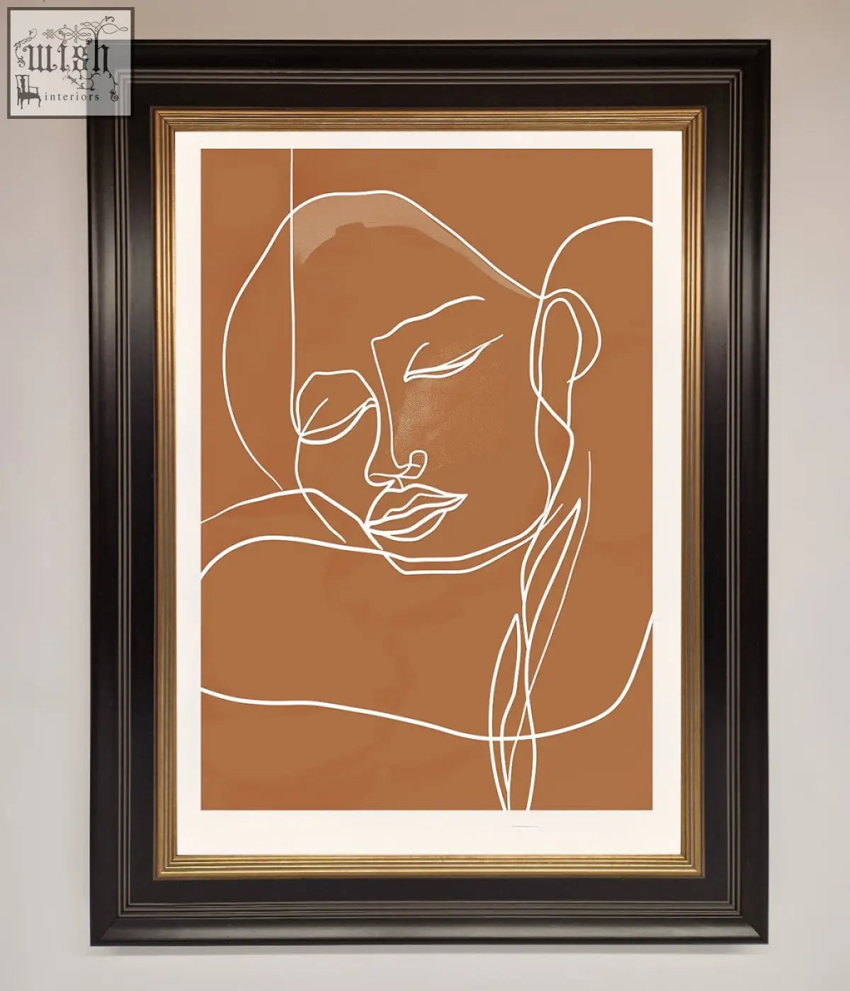 A minimalist sepia lines framed wall art with white continuous line portrait in a black frame with gold inner trim