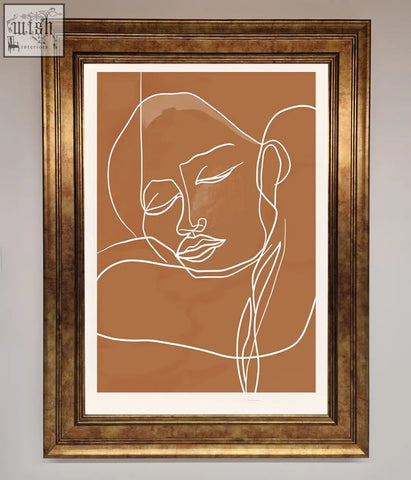 A sepia lines framed minimalist line art of a serene face in white on terracotta background in gold frame wall art